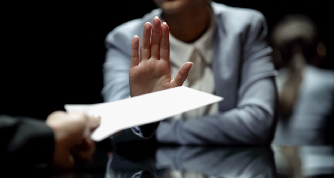 Female official refuses to take bribe, anti-corruption laws in action, close up