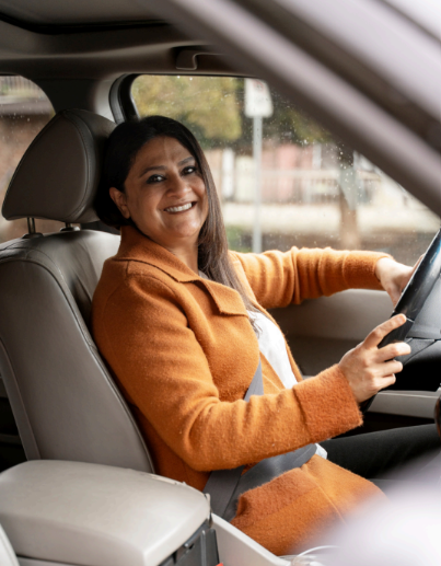Woman driver at the wheel of an electric taxi