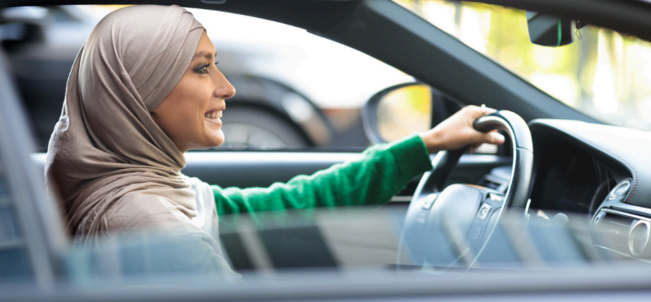 Woman driver at the wheel of an electric vehicle