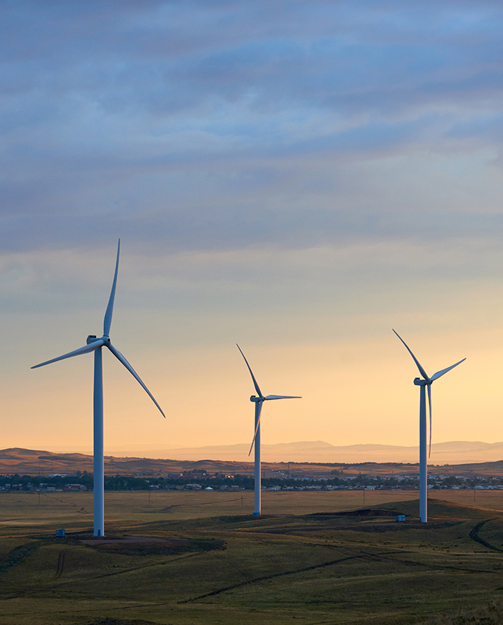 publication image wide shot of wind turbines during sunset