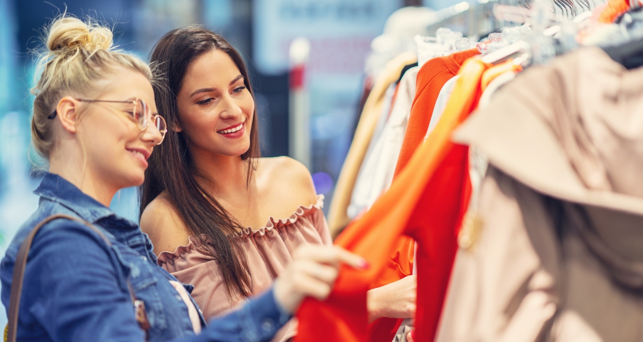 Picture of girl friends shopping for clothes in store