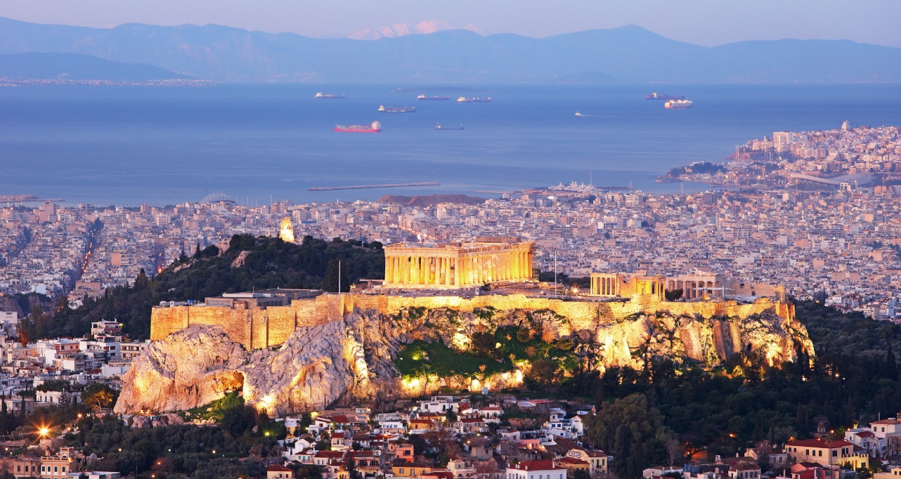 Cityscape of Athens with illuminated Acropolis hill, Pathenon and sea at night, Greece Cityscape of Athens with illuminated Acropolis hill, Pathenon and sea at night, Greece