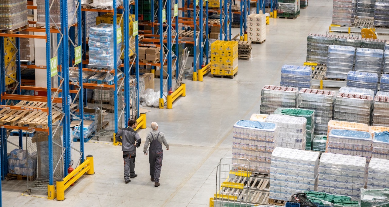 Mid adult and a senior worker working in a warehouse