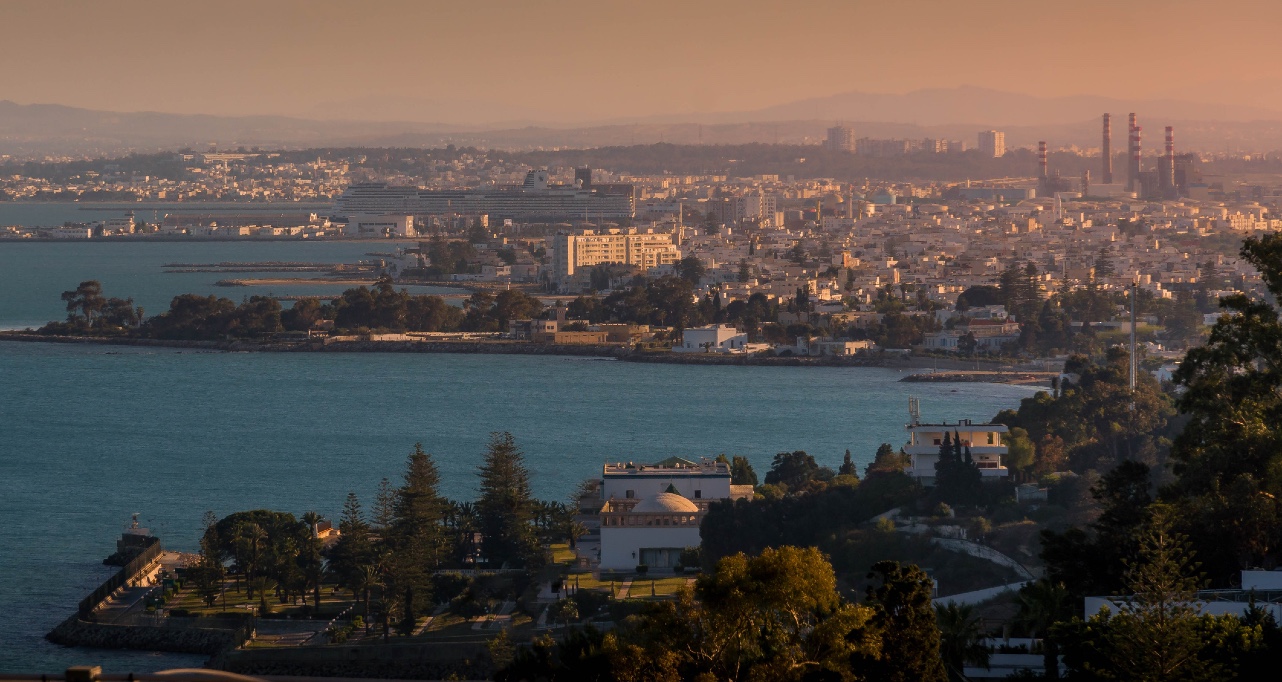The Tunis city panorama from Carthage hill during the scenic sunset with the Mediterranean sea and residential areas.