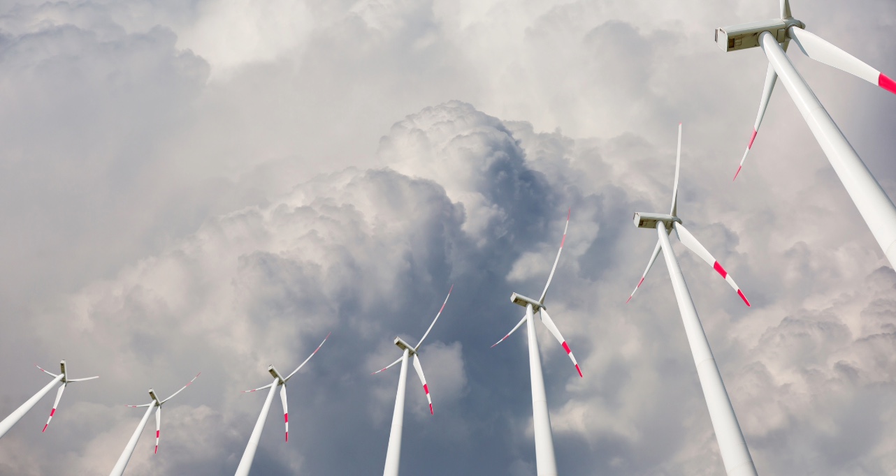 Wind turbines generating electricity with dark cloudy sky
