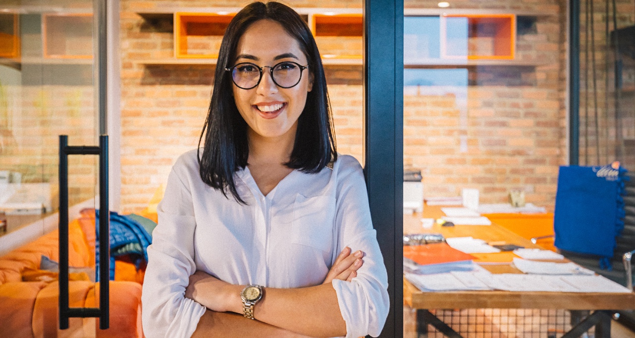 Portrait of young business woman smiling and look at camera posing with crossed arms