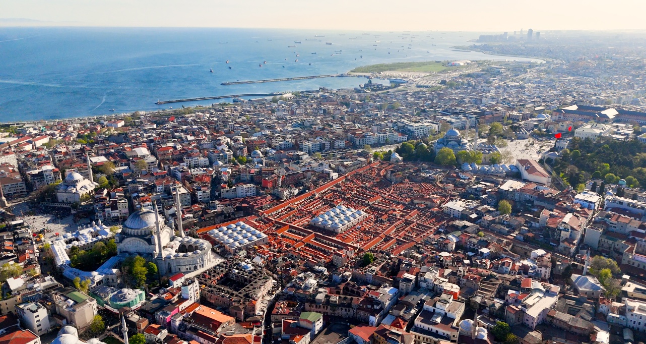 Drone Aerial pans across city skyline to Fatih, Eminönü, Taksim, Galata, Bay and Bridges. İstanbul, Türkiye