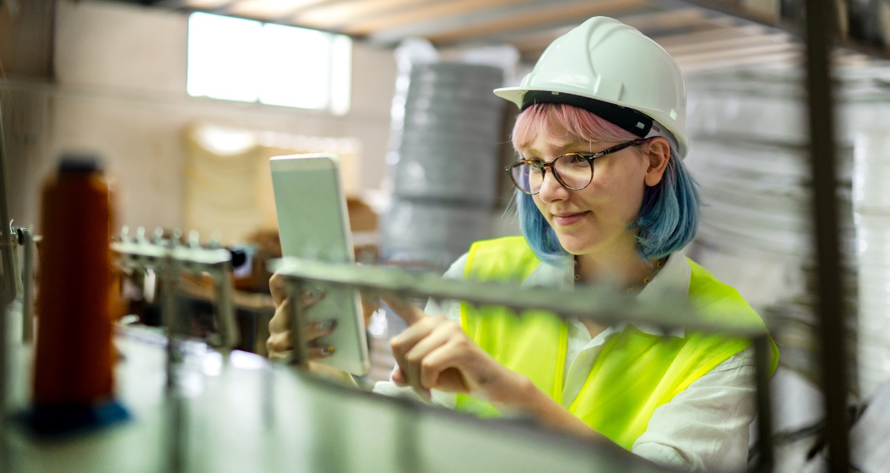 Young female engineer doing quality control in a factory